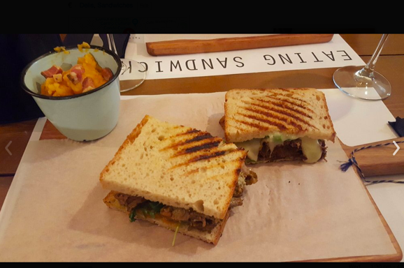 A sandwich cut in half on a plate

Description automatically generated
